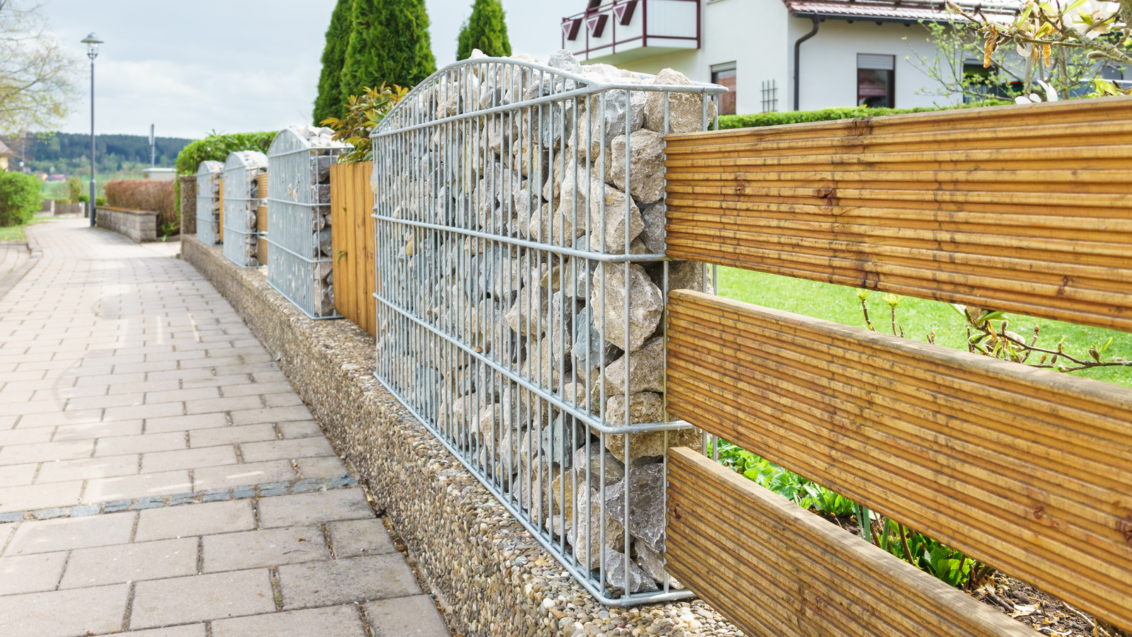 Gabionenzaun mit Holzelementen am Plattenweg